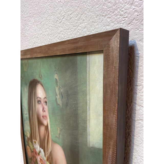 This oil on panel artwork depicts a young woman holding a lush bouquet of flowers, her gaze directed thoughtfully towards...