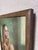 This oil on panel artwork depicts a young woman holding a lush bouquet of flowers, her gaze directed thoughtfully towards...