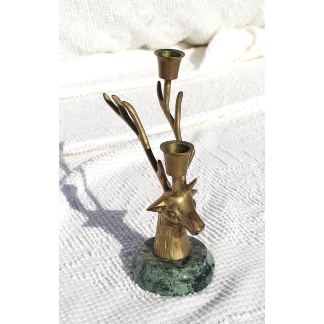Brass metal deer candlesticks with great detailing and a green marble base. Deer head with antlers that branch out for a...