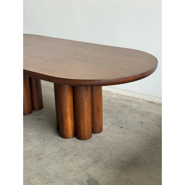 W96.5 D44.5 H30 KC27 This minimalist silhouette features a large racetrack repurposed vintage oak tabletop with sculptural...