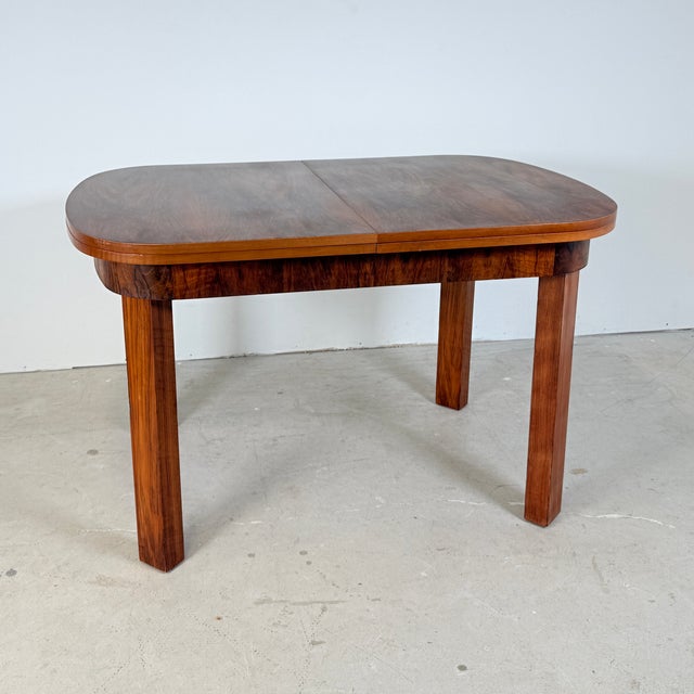 What makes this table unique is its stunning two-tone contrast. The main tabletop is beautifully veneered with dark...
