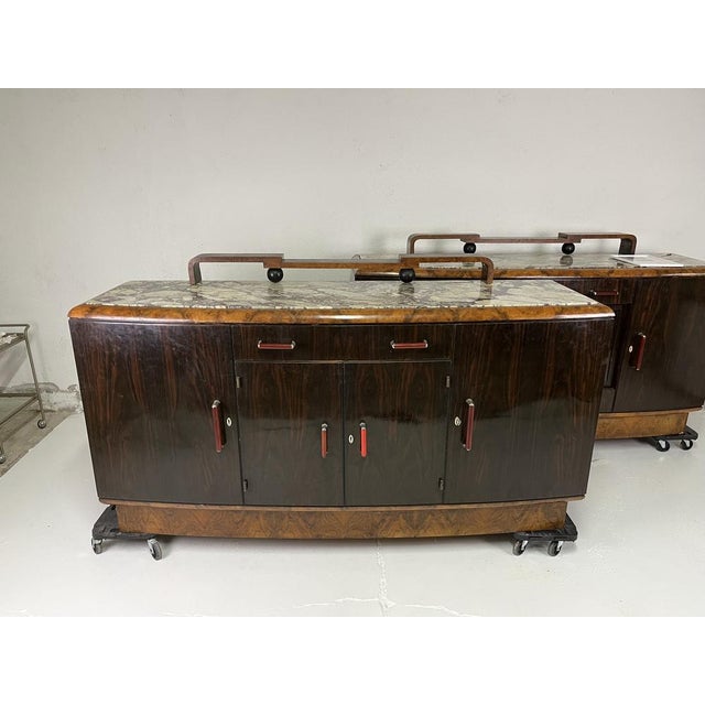 Pair of sideboards in briarwood, marble and bakelite designed by Gaetano Borsani for Atelier di Varedo in the 1930s. The...