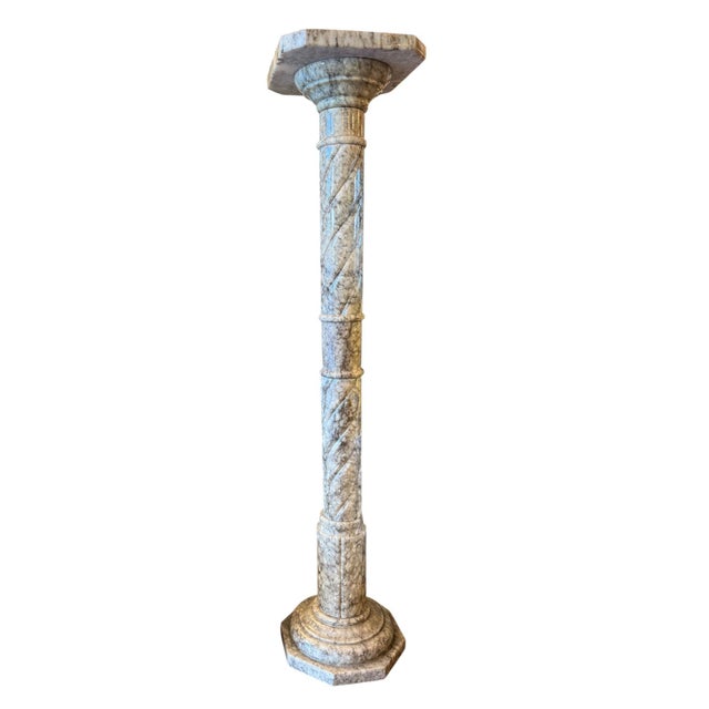 An elegant pair of slender Italian carved marble pedestals, dating to the 20th century. Each pedestal is finely...