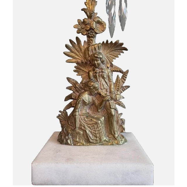 This exquisite Victorian figural candelabra set in antique gilt is a pair of large, intricate gold candlestick holders...