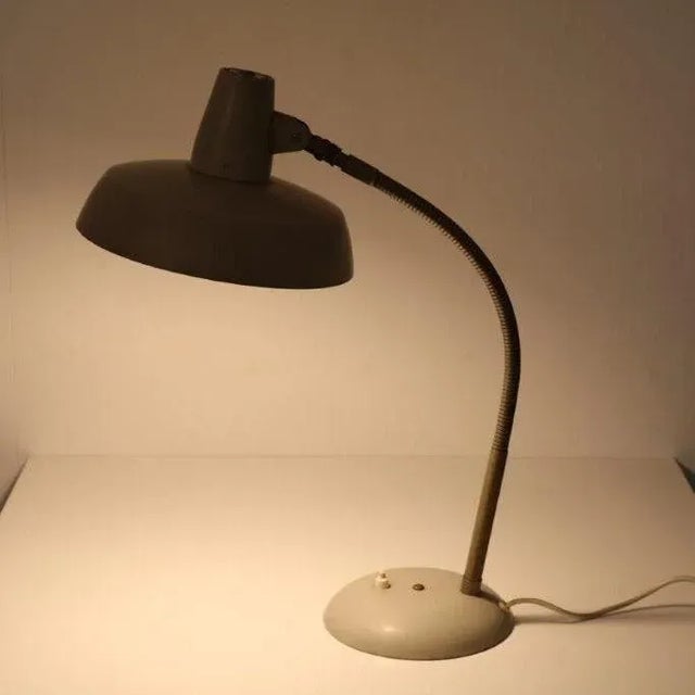 A nice, adjustable desk lamp in German design by SIS. This nice piece is made of grey lacquered metal and has an...