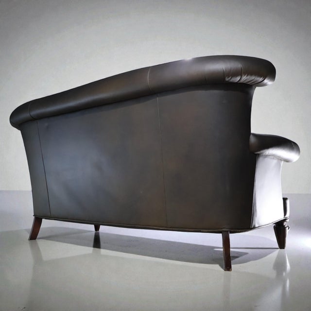 A sculptural leather sofa redefined through a refined LOOM studio transformation. This piece has been carefully restored...