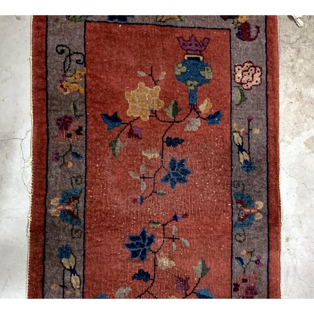 Handmade antique Art Deco Chinese rug in red shade with greyish border. The rug has traditional floral Art Deco design. It...