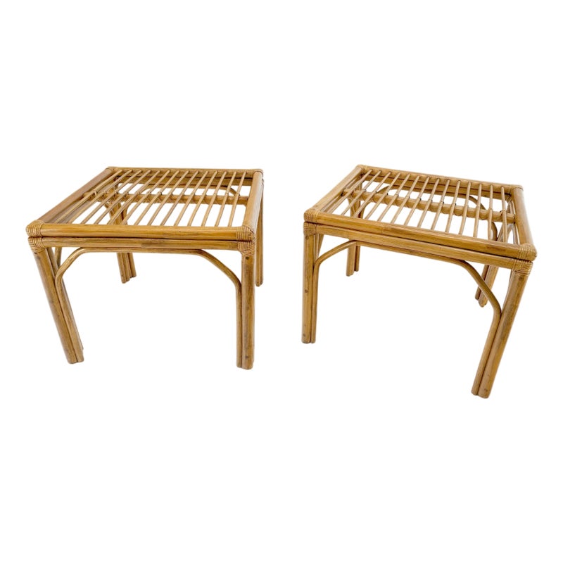 Two light brown bamboo tables with slatted tops and four legs