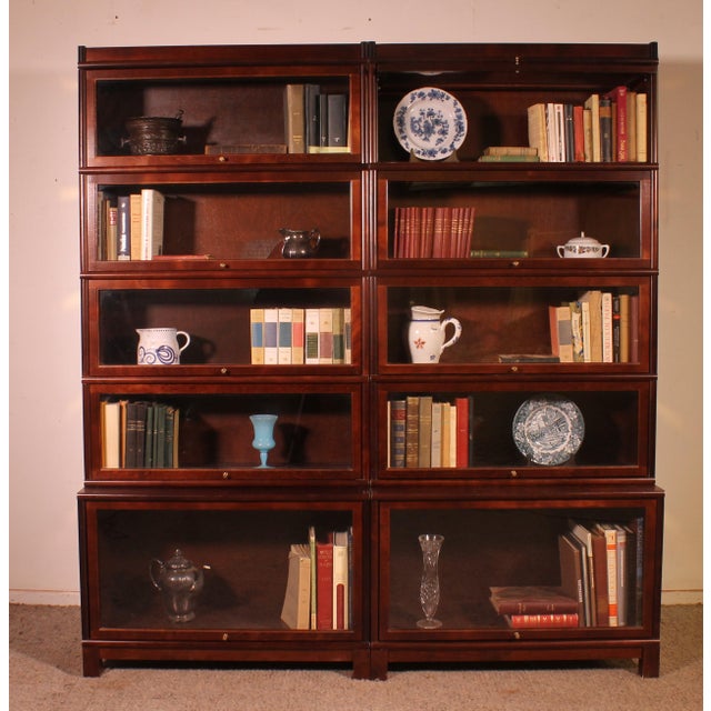 Elegant pair of stacking bookcases from the late 20th century. This charming pair of bookcases features overhanging...