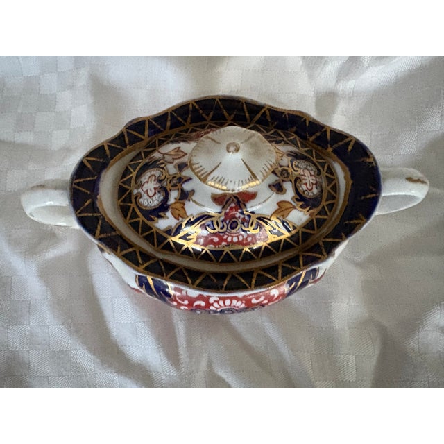 This is an antiques Royal Crown Derby covered sugar bowl featuring a classic Imari style pattern. The sugar bowl is hand...