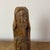 Naïve sculpture of a religious figure in carved wood, folk art. What distinguishes folk art is its deep connection to...