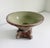 A wonderful celadon-glazed terracotta vessel with Italianate detailing. It features a wide, flared shallow basin supported...