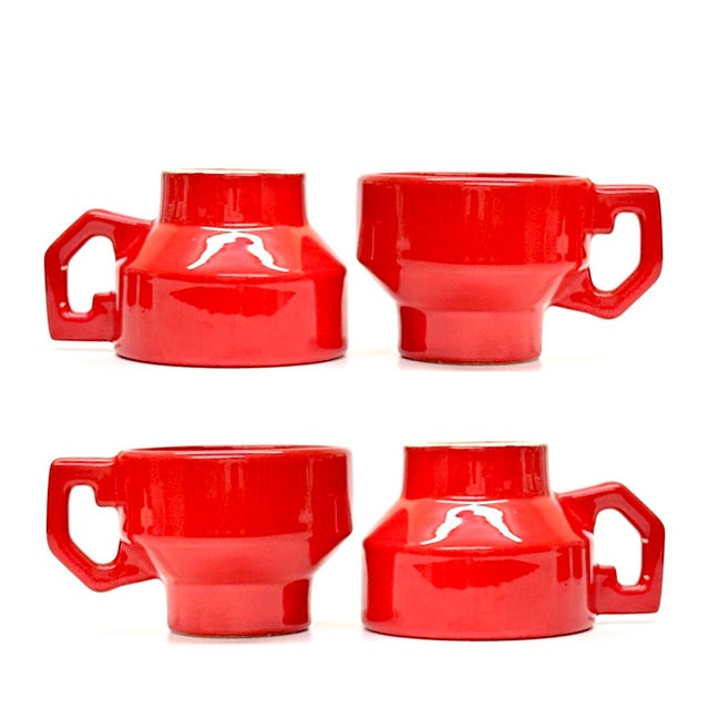 Red ceramic mugs, group of 4. This vibrant and rare set of fire-engine red, high-gloss ceramic mugs brings a bold pop of...