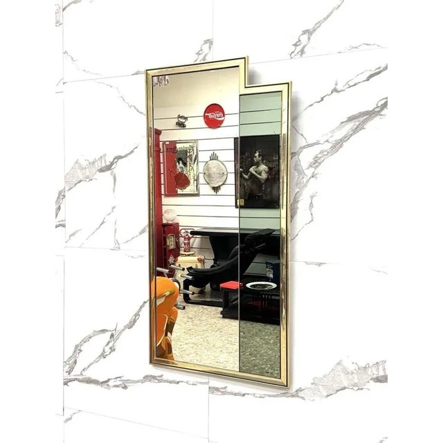 Made n Italy Iconic wall mirror with strong visual impact, made in Italy in the 1970s. Its double-level geometric frame...