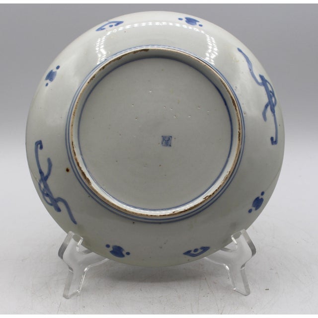 Circa 1890s signed Imari plate, Japanese. With reserves of white pine trees with their colorful Spring cones alternating...