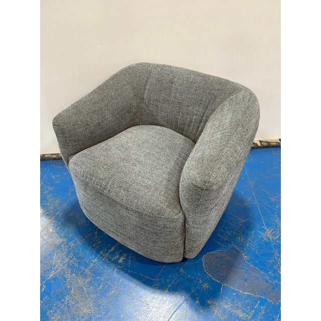 Stylish Modern Swivel Chair with Gray Nubby Fabric. Curved boxy design. Showroom floor sample.