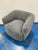 Stylish Modern Swivel Chair with Gray Nubby Fabric. Curved boxy design. Showroom floor sample.
