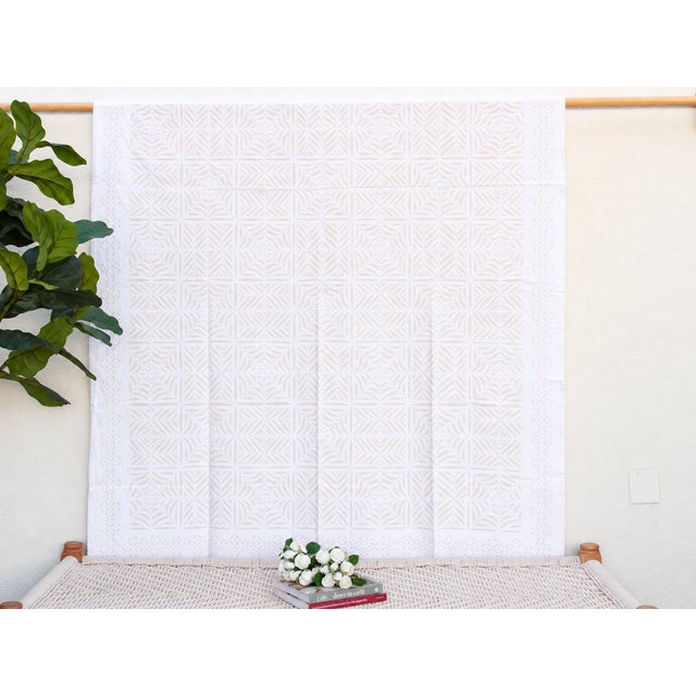 A lightweight cotton coverlet from Western India, beautifully adorned with intricate handcrafted appliqué cutwork. The...