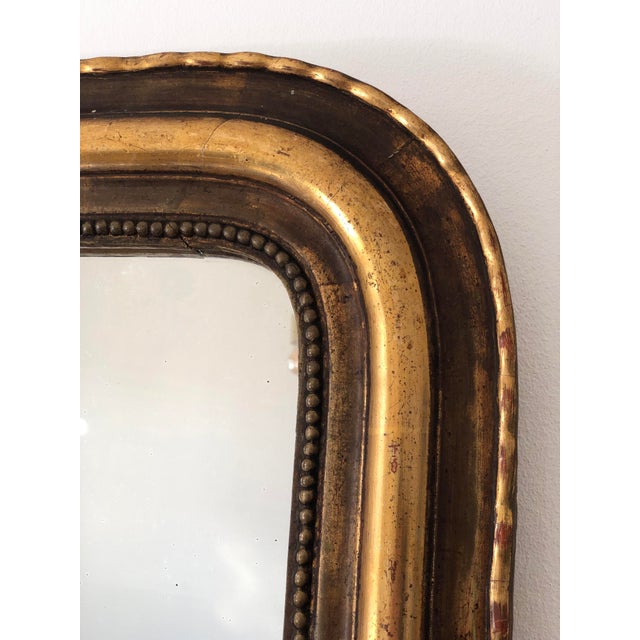 Antique French Louis Philippe mirror, dating to the late 19th century. The mirror features a giltwood frame with a warm,...