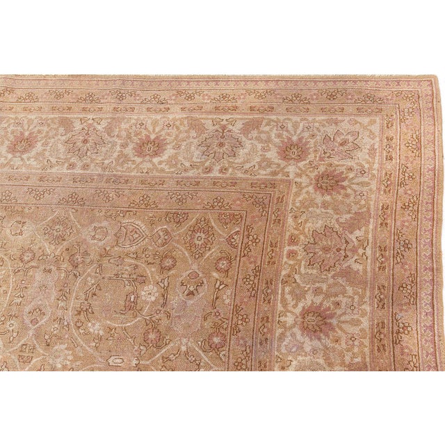 A late 19th century Indian Amritsar antique carpet, the beige field with an allover pattern of enlarged ivory scrolling...