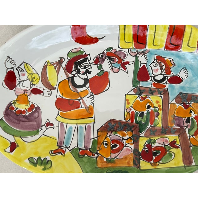 A vibrant piece of vintage Italian art pottery, this La Musa hand-painted oval serving platter captures the whimsical...