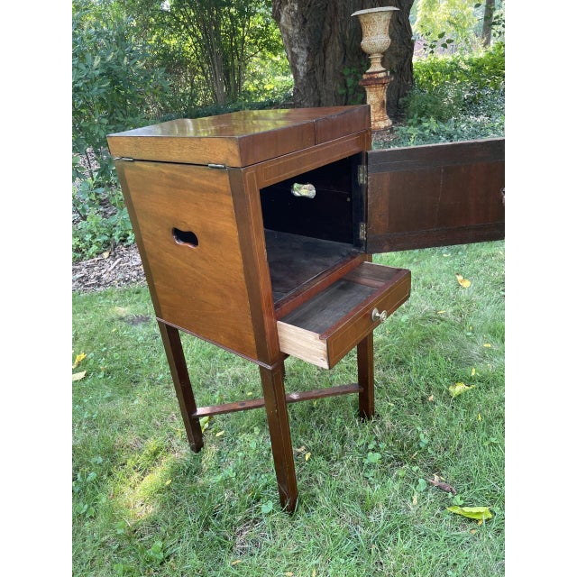 English 19th century Sheraton style washstand in Mahogany with oak as the secondary wood. When the top is opened it...