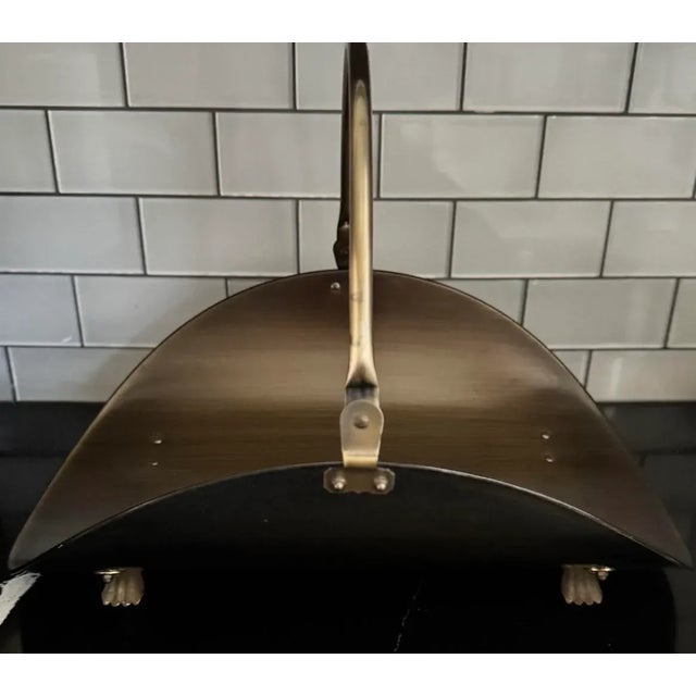 Elegant in form and substantial in scale, this mid-century brass firewood holder captures the quiet luxury of the...