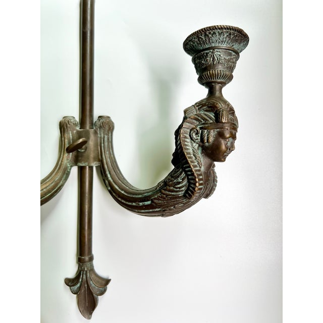 This is a pair of vintage bronze wall sconces featuring an elegant neoclassical design. Each two-arm sconce showcases...