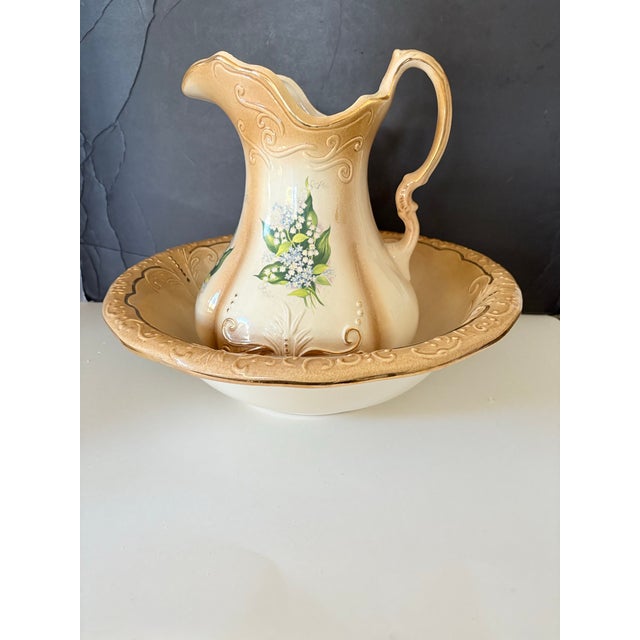 Antique RS Prussia porcelain pitcher and basin set featuring delicate lily of the valley florals and richly embossed gilt...
