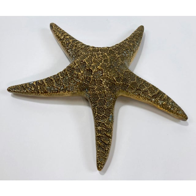 Vintage Hollywood Regency style heavy cast brass starfish paper weight. Beautiful detail to both sides. Hook for hanging....