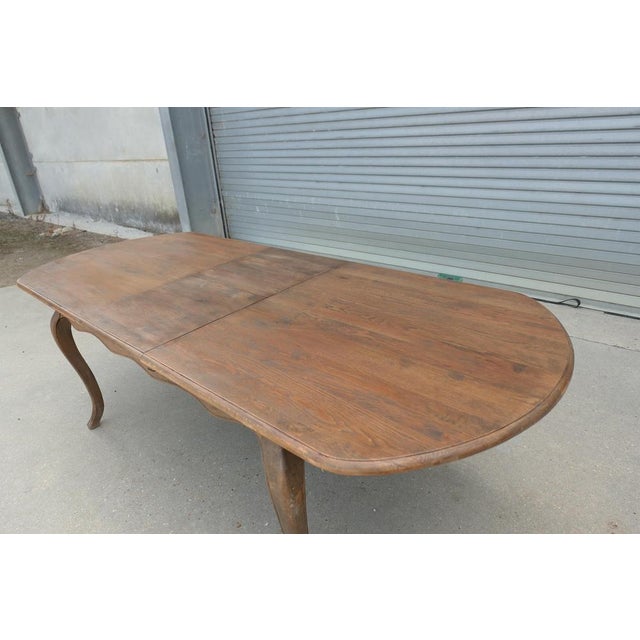 A Large French Elm Extending Dining Table This table comes from France the table top extends by pulling each end away and...