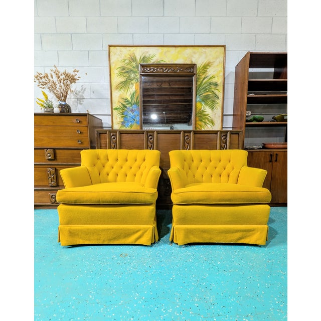 The are a cool pair of vintage tufted lounge chairs in a yellow fabric and walnut legs under the skirt. They are a...
