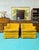 The are a cool pair of vintage tufted lounge chairs in a yellow fabric and walnut legs under the skirt. They are a...