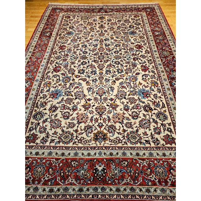 An exquisite vintage Persian Isfahan rug, hand-knotted with remarkable precision in the mid 20th century. This elegant...