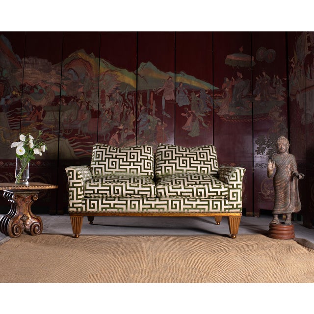 A dramatic custom mid-century settee crafted in an Art Deco style featuring a striking Greek key velvet upholstery with...