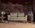 A dramatic custom mid-century settee crafted in an Art Deco style featuring a striking Greek key velvet upholstery with...