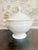 Antique French white porcelain soup tureen, circa late 19th to early 20th century. Round body on a pedestal foot, domed...