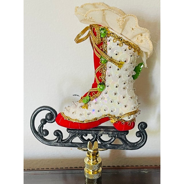 Vintage beaded skating shoe toy mounted on brass base as lamp finial.