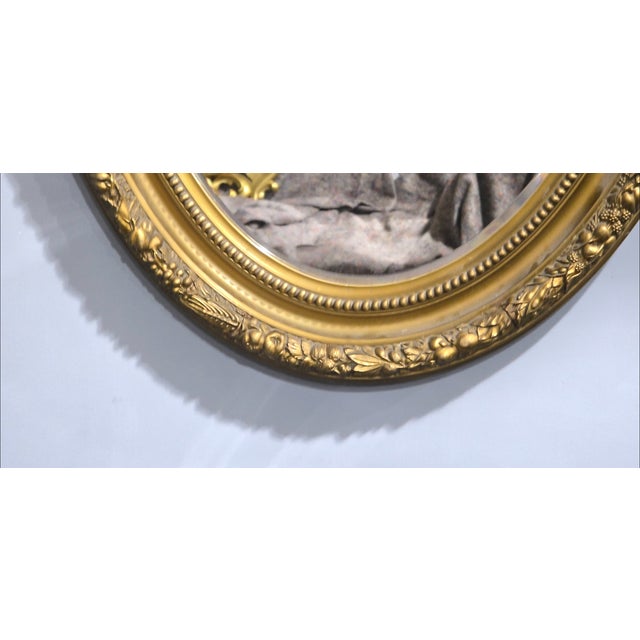 A very good Victorian oval gilt gesso wall mirror with fruit and vine decoration, original bevelled mirror, in very good...