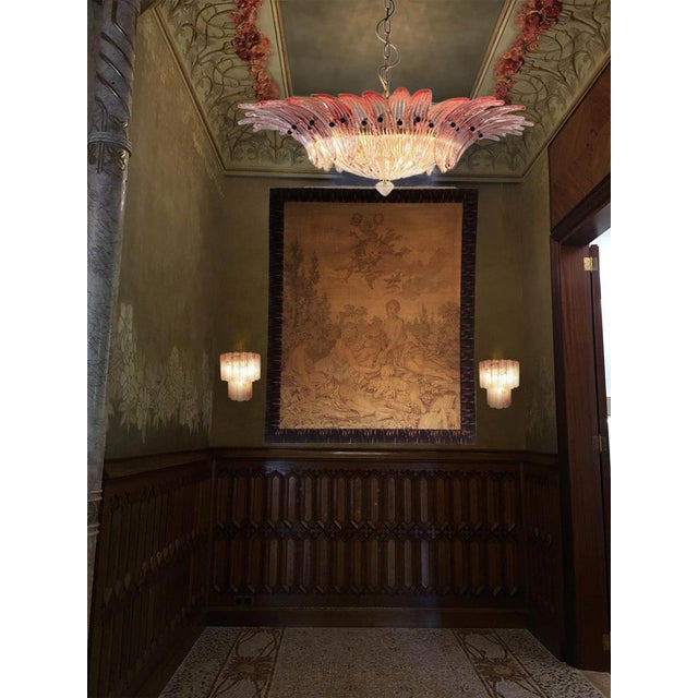 Pair murano glass chandeliers. Hand made in murano. It made by 36 murano pink glasses in a gold painted metal frame. The...