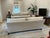 Two Lee Industries sofas upholstered in neutral ivory herringbone, with reversible down-filled cushions and matte nickel...