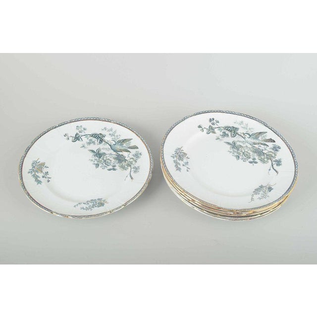Gustavsberg “Wexiö” faience, c. 1900. Six lunch plates in faience with decoration of a bird and a flowering branch in...