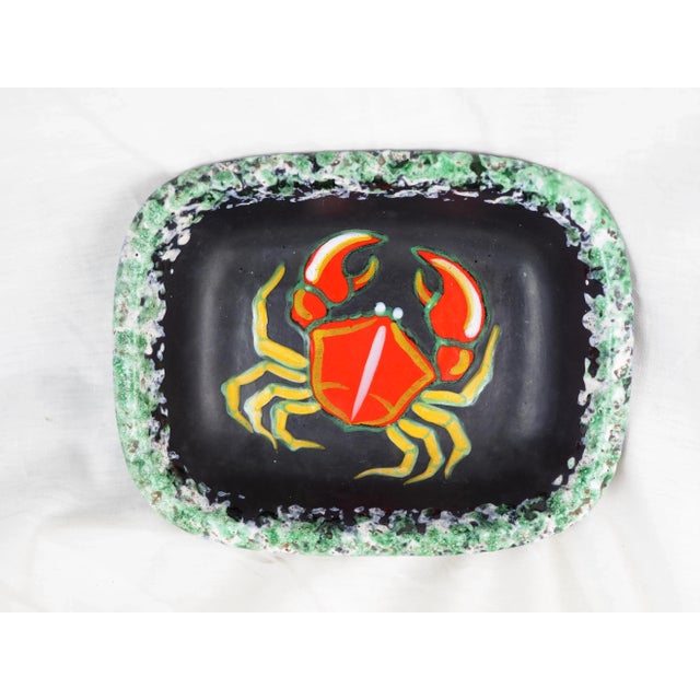 Black glazed pin tray with green foam glaze border and pop crab in the bottom. Created by Gabriel Fourmaintraux...
