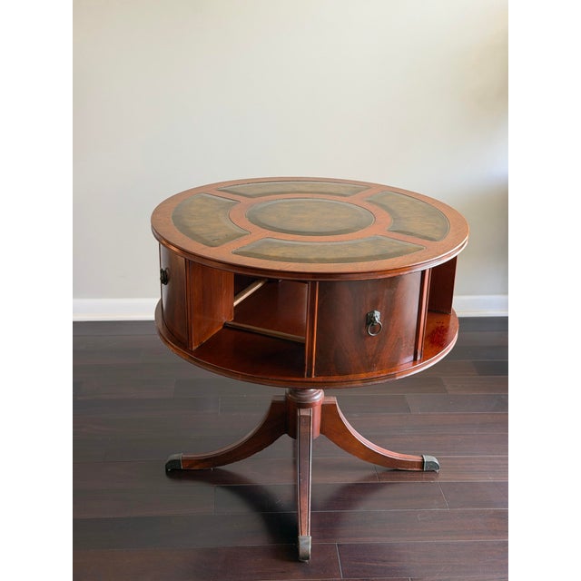 An elegant vintage revolving drum library table crafted in the Duncan Phyfe tradition with a mahogany finish, inset...
