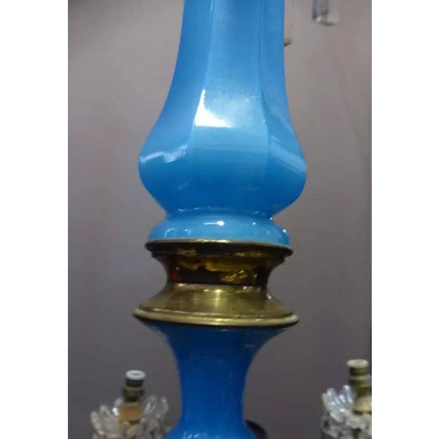 Napoleon III period blue opaline chandelier. It has six arms of light, decorated with copper brass and pendants. To note...