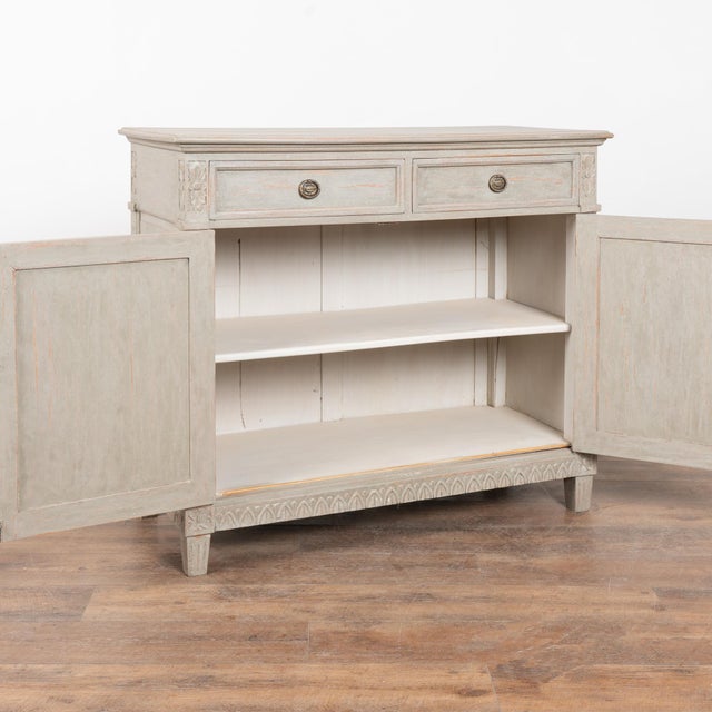Late 19th century Swedish Gustavian style sideboard or buffet crafted in pine with two drawers over fluted cabinet doors....