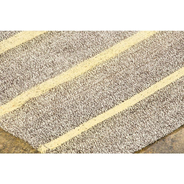 Hand-woven in pure goat hair and originating circa 1950-1959, this 5x8 vintage Turkish kilim rug joins Rug & Kilim’s Kilim...