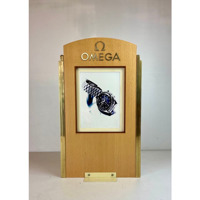 Point-of-sale advertising for the luxurious Omega watch brand, made of wood and brass, from the 1980s. Can be used as a...