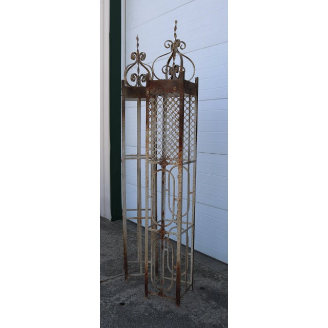 Unique, large garden trellises made of wrought iron and intentionally distressed. I love the mesh and floral accents....