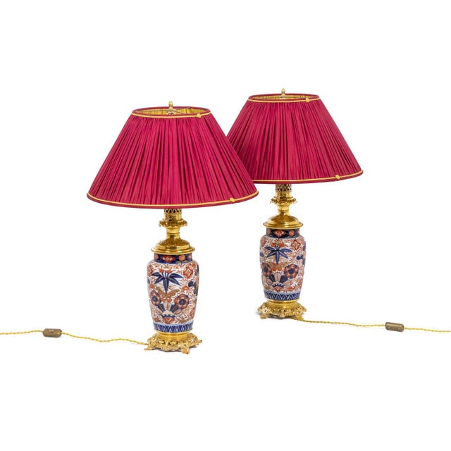 Pair of Imari porcelain lamps decorated with blue and orange flowers. French work made circa 1880. Gilt bronze mount. This...